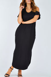 Model Laura wearing size 14 of The Shoulder Splice Maxi Dress in colour Black (Black), from the front, cropped image