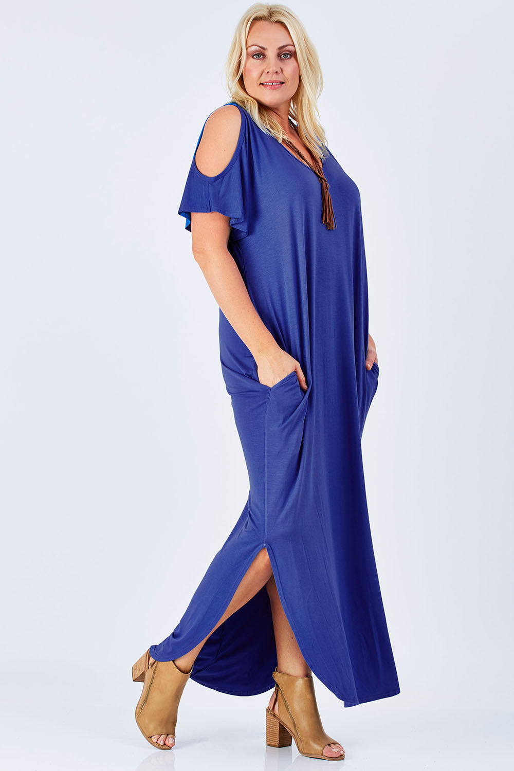 Model Natalie wearing size 16 of The Shoulder Splice Maxi Dress in colour Splash (Blue), from the front, showing the whole outfit