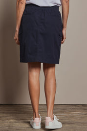 Model Amanda wearing size 10 of The Cotton Cargo Skirt in colour Navy (Blue), from the back