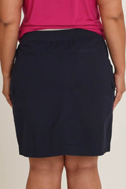 Model Ashleigh wearing size 16 of The Cotton Cargo Skirt in colour Navy (Blue), from the back