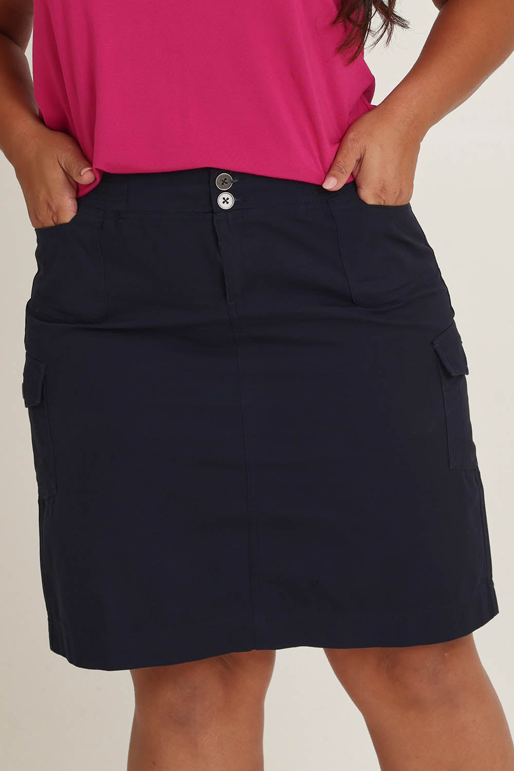 Model Ashleigh wearing size 16 of The Cotton Cargo Skirt in colour Navy (Blue), from the front, cropped image