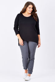 Model Mae wearing size 16 of The Relaxed Long Sleeve Tee in colour Black (Black), from the front, showing the whole outfit