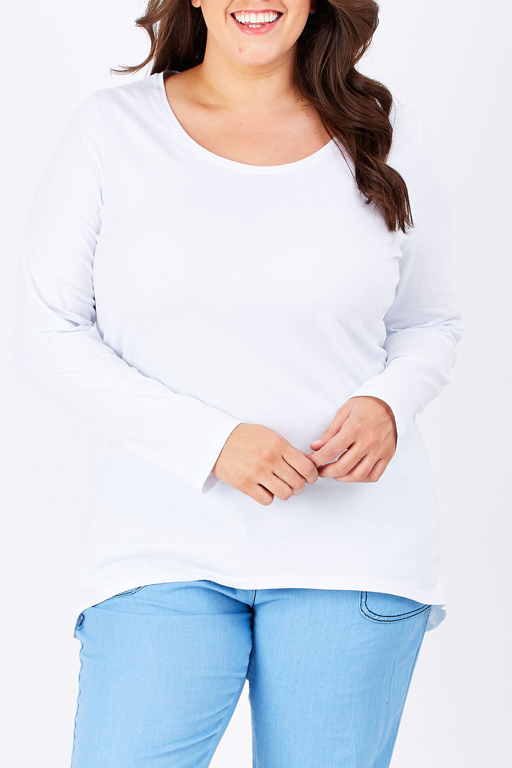 Model Mae wearing size 16 of The Relaxed Long Sleeve Tee in colour White (White), from the front, cropped image