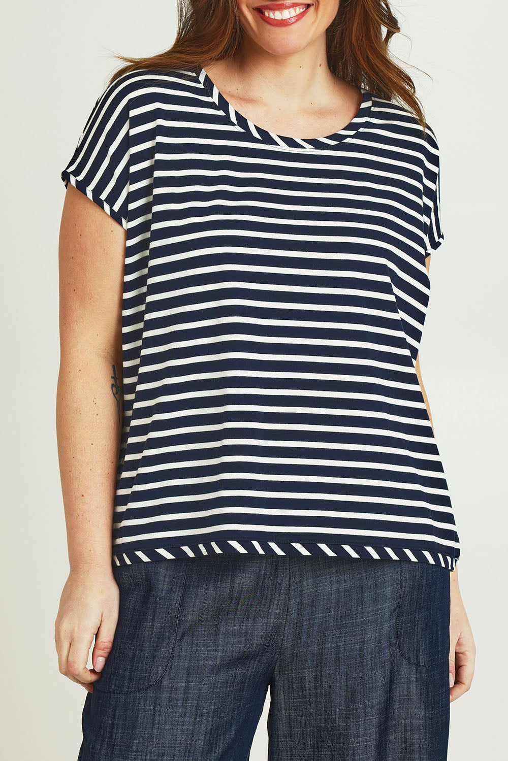 Model Jane wearing size 14 of The Striped Drape Tee in colour Navywhite (Blue), from the front, cropped image
