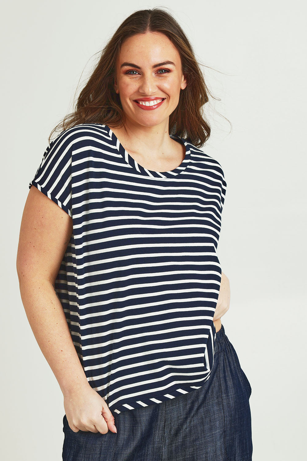 Model Jane wearing size 14 of The Striped Drape Tee in colour Navywhite (Blue), from the front, cropped image