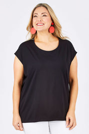 Model Ljubenka wearing size 18 of The Drape Tee in colour Black (Black), from the front, cropped image