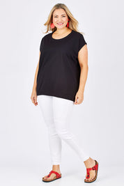 Model Ljubenka wearing size 18 of The Drape Tee in colour Black (Black), from the front, showing the whole outfit