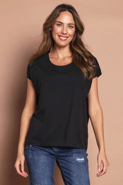 Model Madeline wearing size 10 of The Drape Tee in colour Black (Black), from the front, cropped image