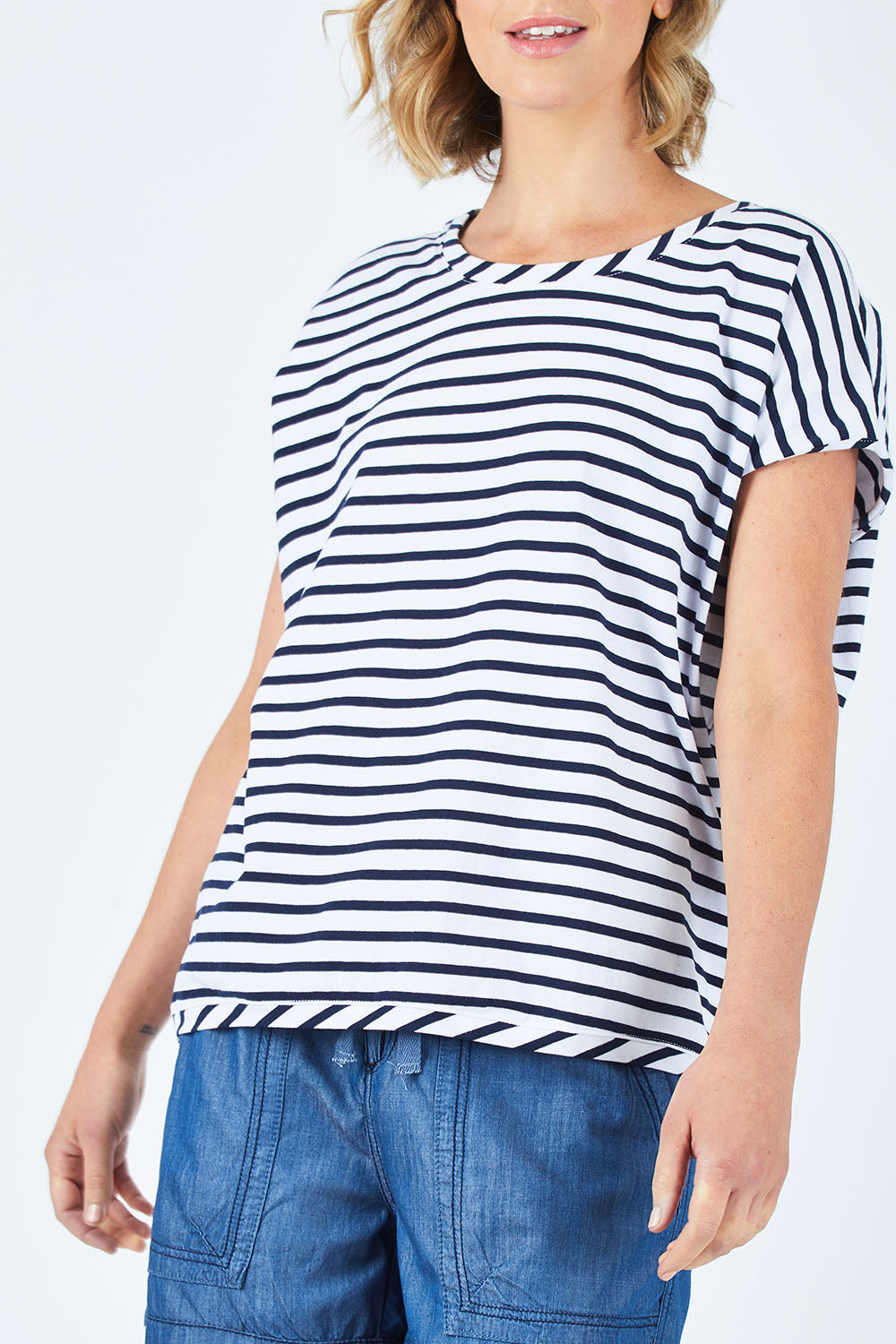 Model Chelsea wearing size 10 of The Drape Tee in colour NavyStripe (Blue), from the front, cropped image