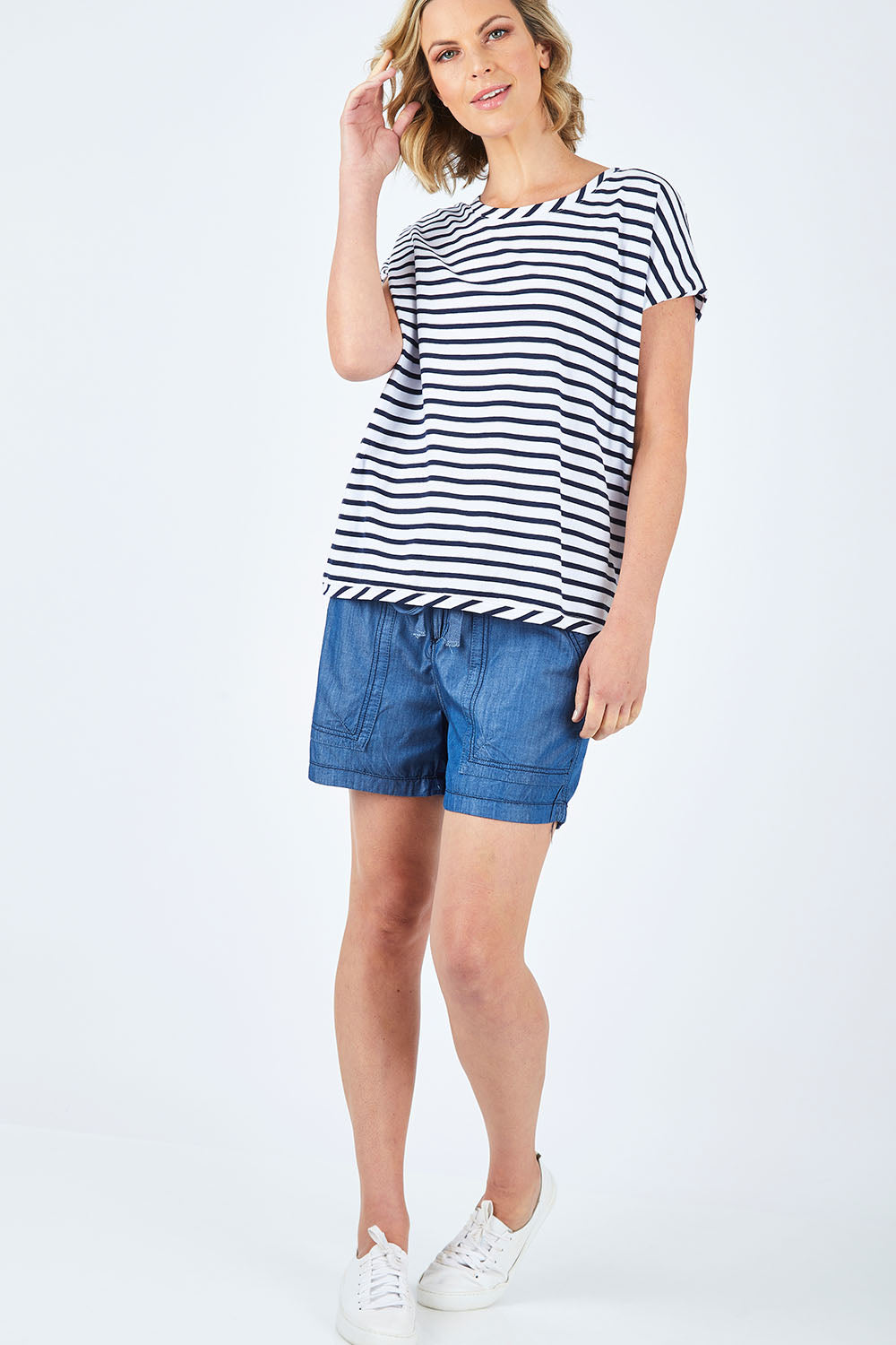 Model Chelsea wearing size 10 of The Drape Tee in colour NavyStripe (Blue), from the front, showing the whole outfit
