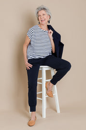 Model Elise wearing size 10 of The Drape Tee in colour NavyStripe (Blue), from the front, showing the whole outfit