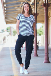 Model Emma wearing size 10 of The Drape Tee in colour NavyStripe (Blue), from the front, showing the whole outfit