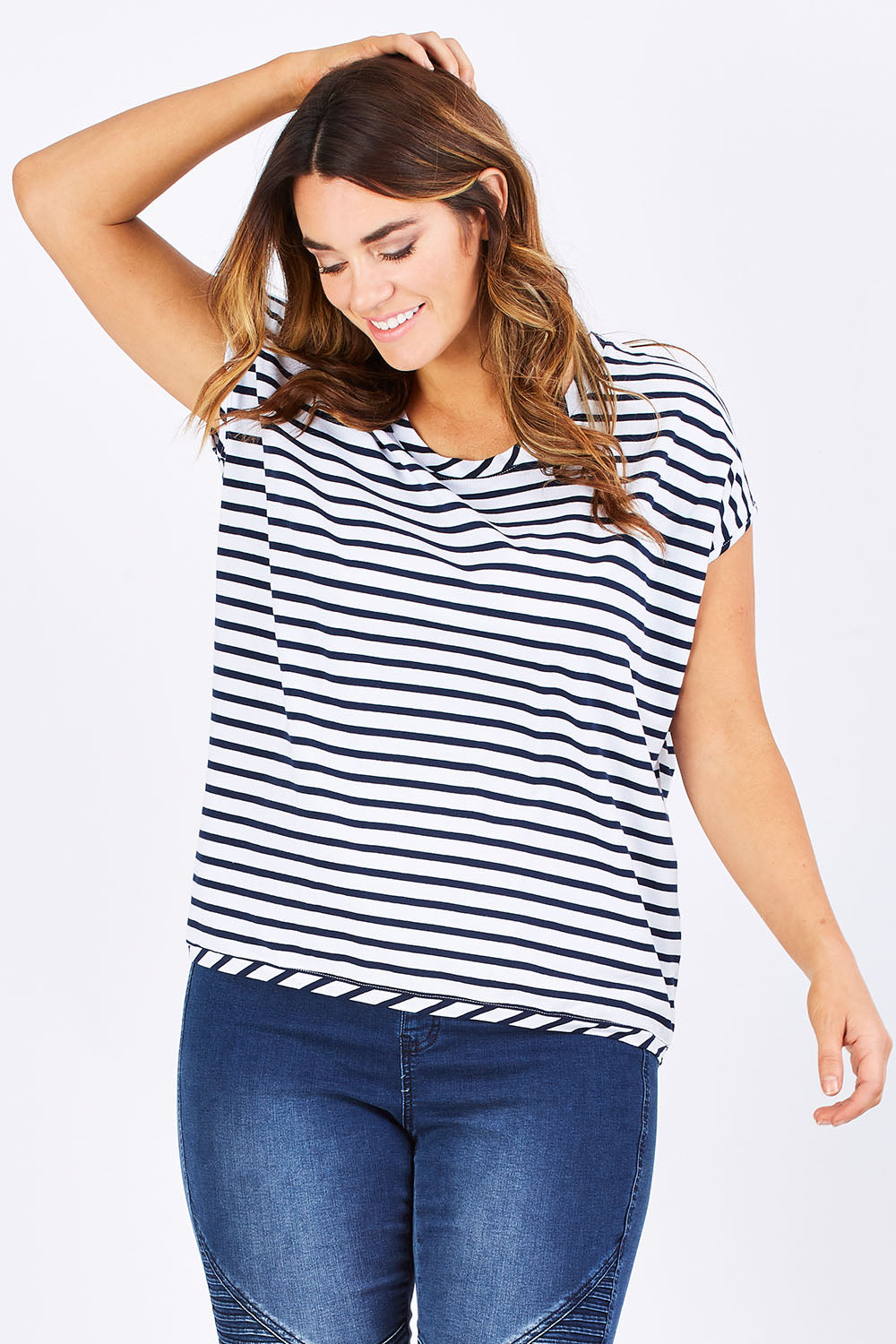 Model Laura wearing size 12 of The Drape Tee in colour NavyStripe (Blue), from the front, cropped image