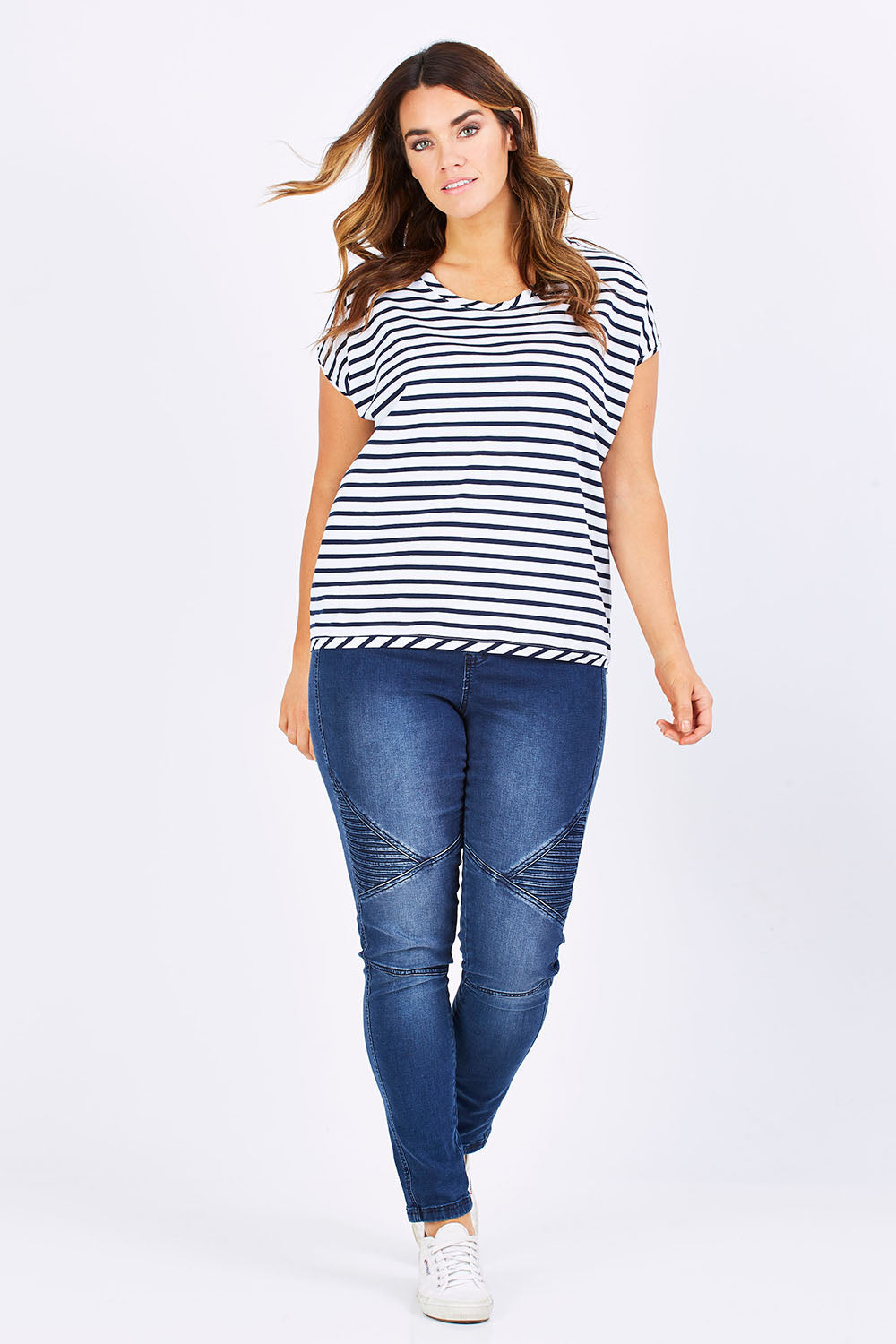 Model Laura wearing size 12 of The Drape Tee in colour NavyStripe (Blue), from the front, showing the whole outfit