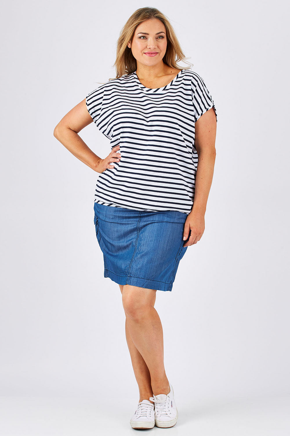 Model Ljubenka wearing size 18 of The Drape Tee in colour NavyStripe (Blue), from the front, showing the whole outfit