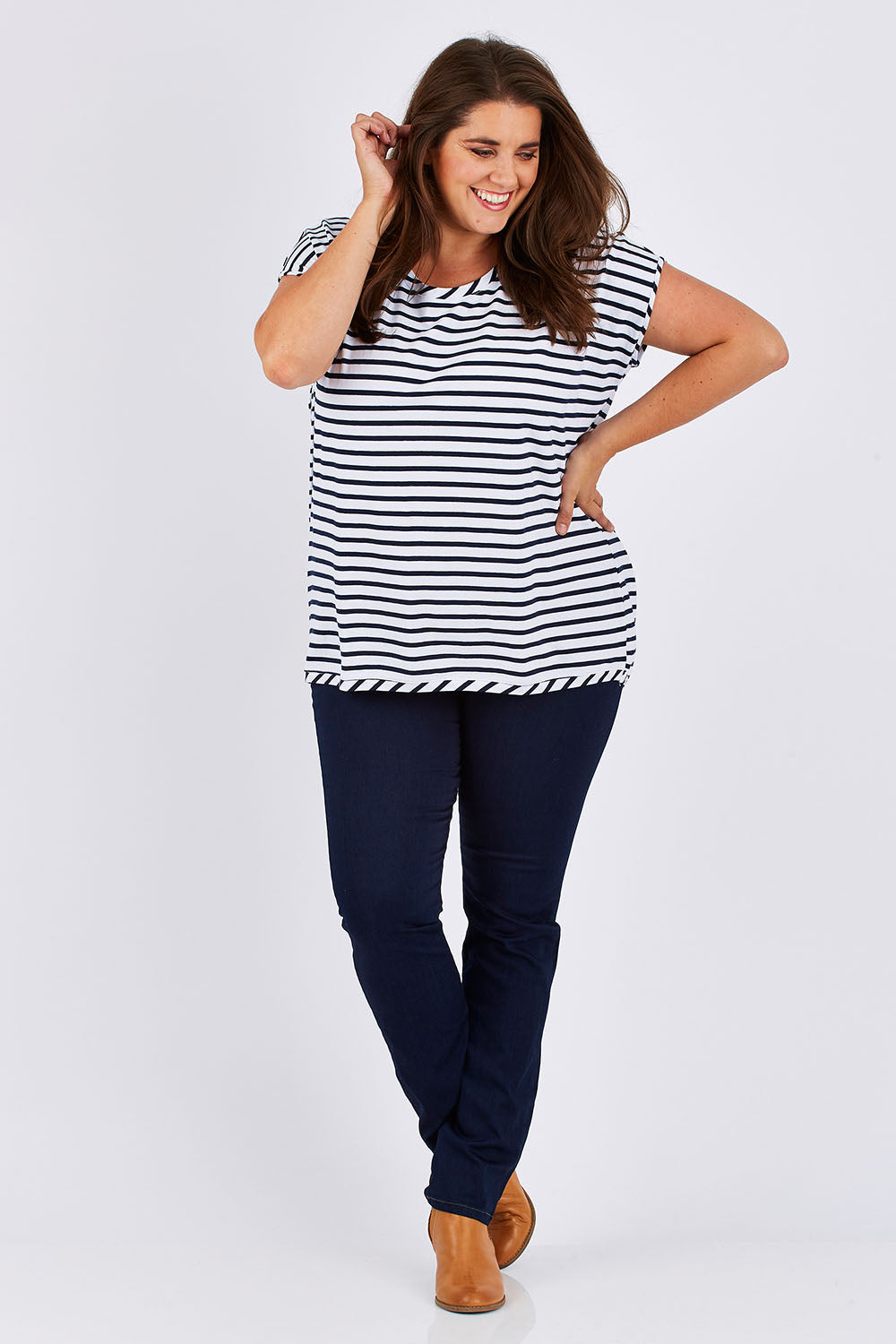 Model Mae wearing size 18 of The Drape Tee in colour NavyStripe (Blue), from the front, showing the whole outfit