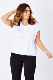 Model Laura wearing size 12 of The Drape Tee in colour White (White), from the front, cropped image