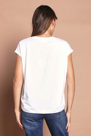 Model Madeline wearing size 10 of The Drape Tee in colour White (White), from the back