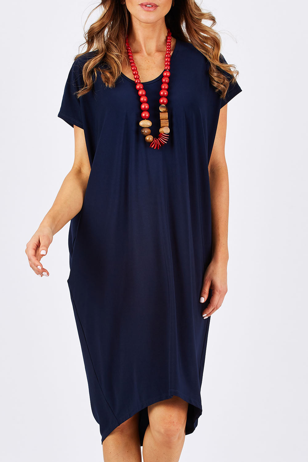 Model Clementine wearing size 10 of The Drape Jersey Dress in colour Navy (Blue), from the front, cropped image