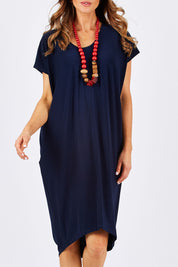 Model Clementine wearing size 10 of The Drape Jersey Dress in colour Navy (Blue), from the front, cropped image