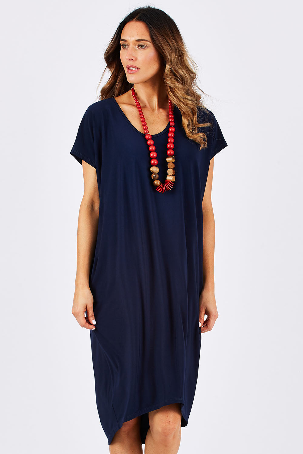 Model Clementine wearing size 10 of The Drape Jersey Dress in colour Navy (Blue), from the front, cropped image