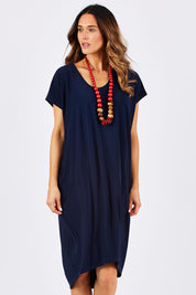 Model Clementine wearing size 10 of The Drape Jersey Dress in colour Navy (Blue), from the front, cropped image