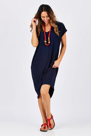 Model Clementine wearing size 10 of The Drape Jersey Dress in colour Navy (Blue), from the front, showing the whole outfit