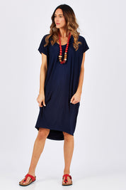 Model Clementine wearing size 10 of The Drape Jersey Dress in colour Navy (Blue), from the front, showing the whole outfit