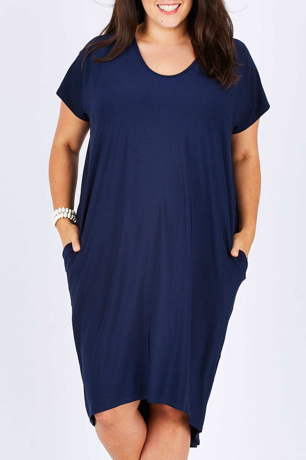 Model Mae wearing size 18 of The Drape Jersey Dress in colour Navy (Blue), from the front, cropped image