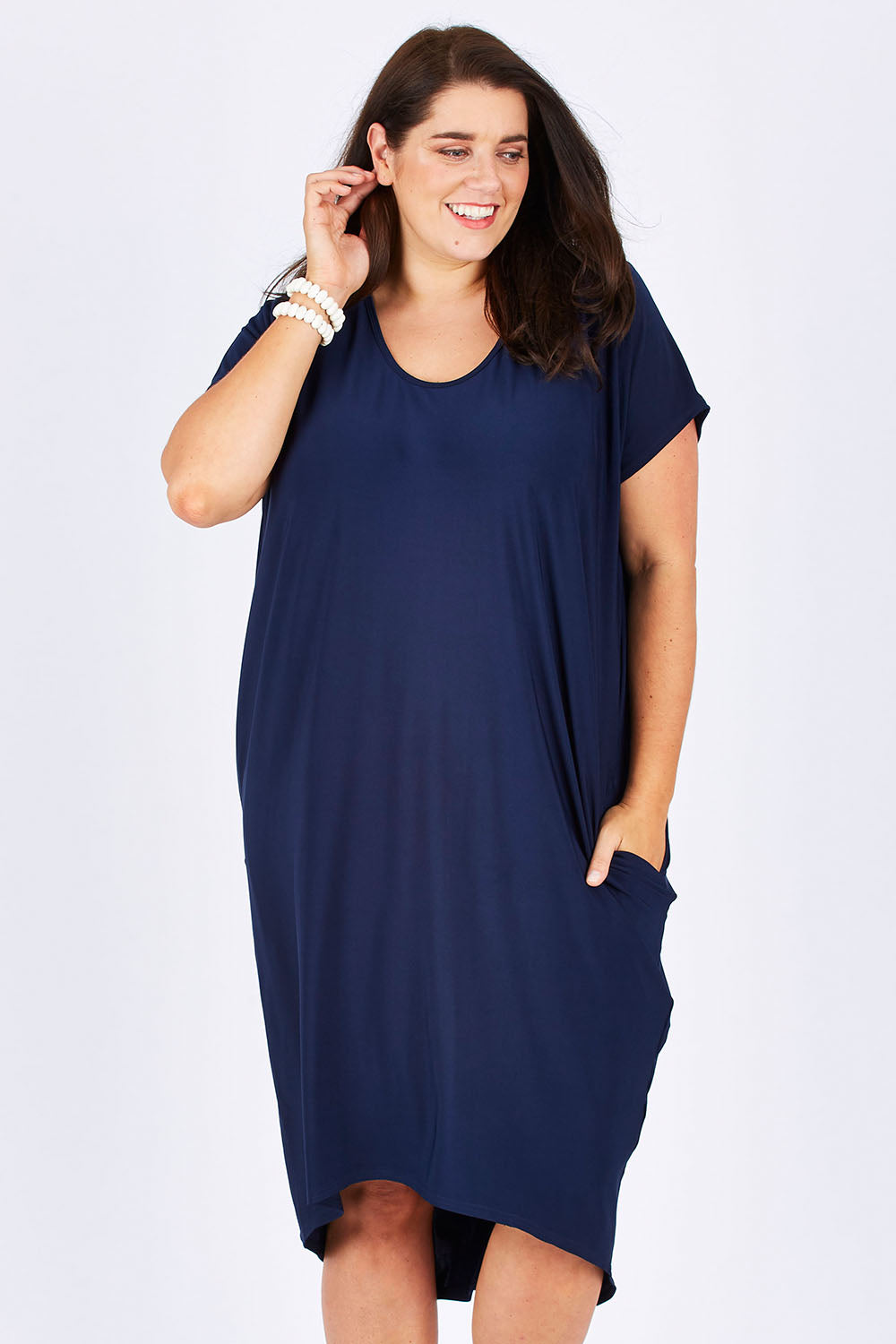 Model Mae wearing size 18 of The Drape Jersey Dress in colour Navy (Blue), from the front, cropped image