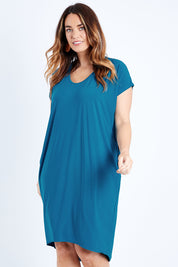 Model Laura wearing size 14 of The Drape Jersey Dress in colour Teal (Blue), from the front, cropped image