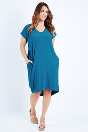 Model Laura wearing size 14 of The Drape Jersey Dress in colour Teal (Blue), from the front, showing the whole outfit