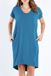 Model Madeline wearing size 10 of The Drape Jersey Dress in colour Teal (Blue), from the front, cropped image