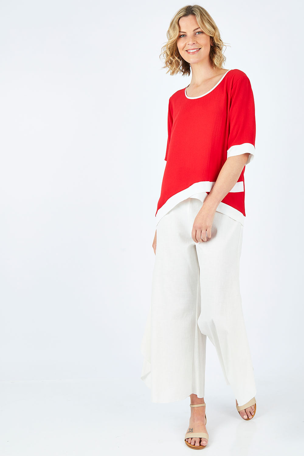 Model Chelsea wearing size 10 of The Contrast Trim Blouse in colour Red (Red), from the front, showing the whole outfit