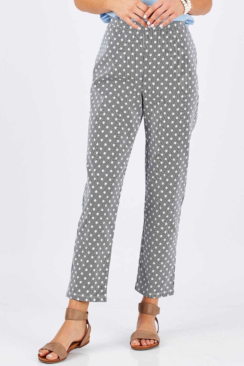 Model Clementine wearing size 10 of The Stretch Spot Pant in colour Navy (Blue), from the front, cropped image