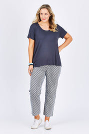 Model Jess wearing size 14 of The Stretch Spot Pant in colour Navy (Blue), from the front, showing the whole outfit
