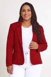 Model Ashleigh wearing size 16 of The Ponte Blazer in colour Brick (Red), from the front, cropped image
