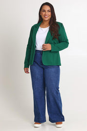 Model Ashleigh wearing size 16 of The Ponte Blazer in colour Pinegreen (Green), from the front, showing the whole outfit