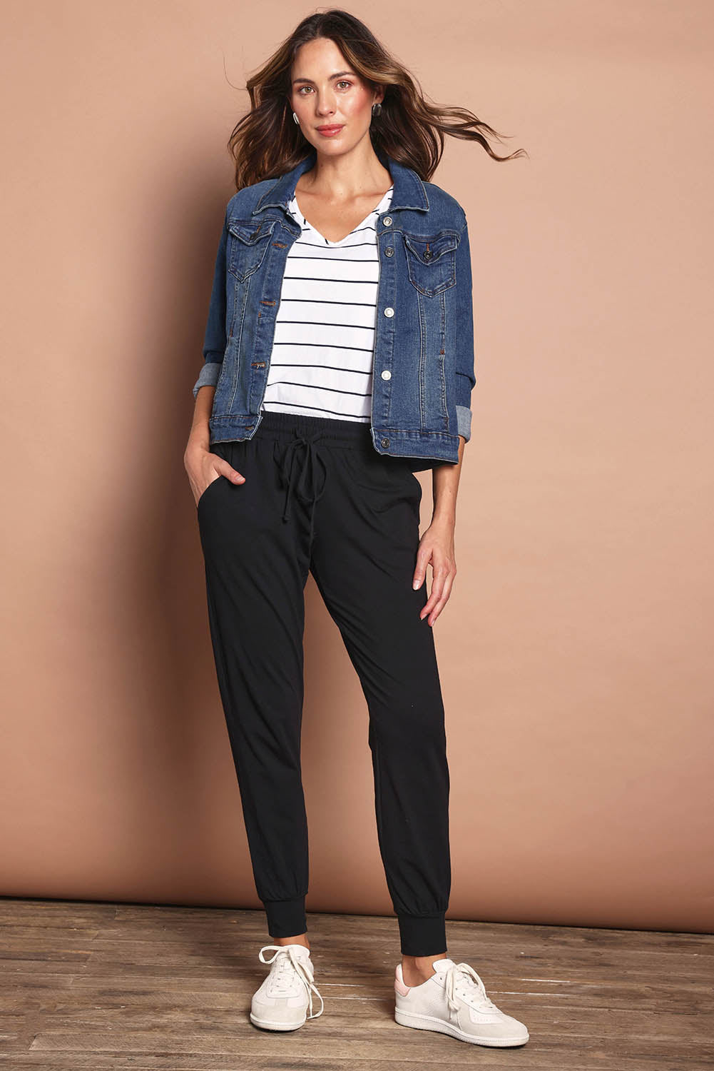 Model Madeline wearing size 10 of The Basic Keeper Pant in colour Black (Black), from the front, showing the whole outfit