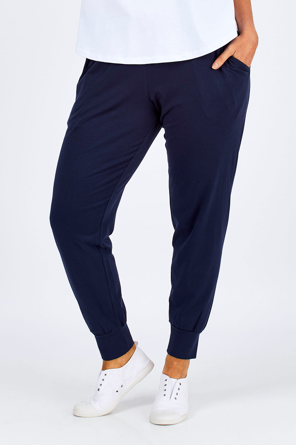 Model Laura wearing size 12 of The Basic Keeper Pant in colour Ink (Blue), from the front, cropped image