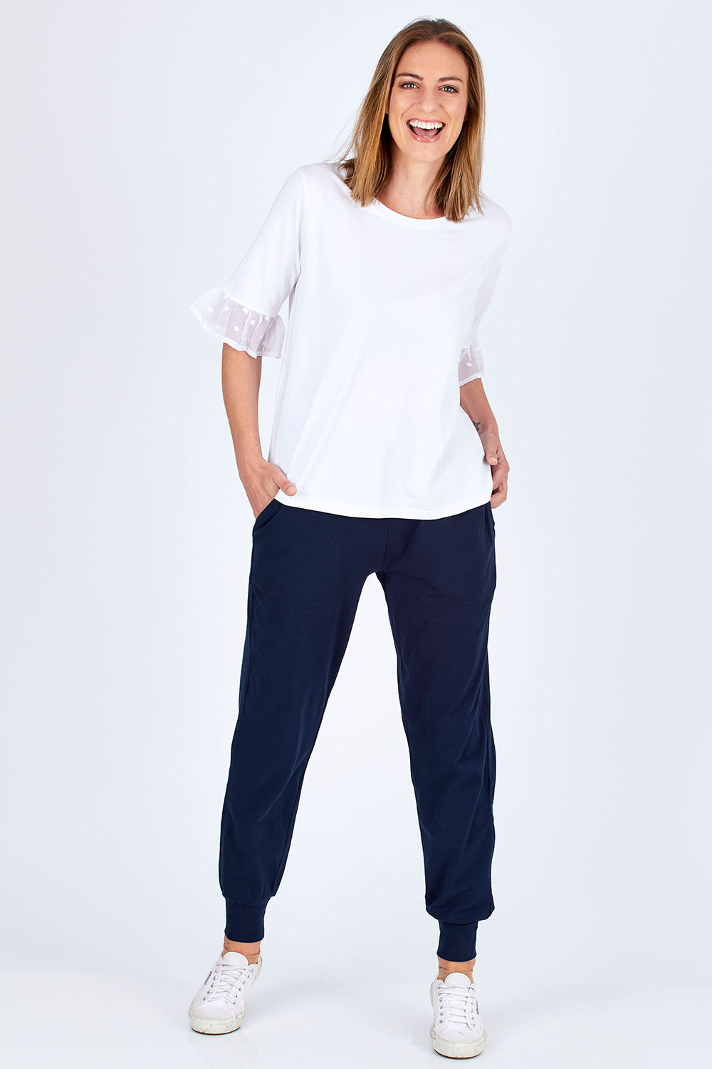 Model Riina wearing size 10 of The Basic Keeper Pant in colour Ink (Blue), from the front, showing the whole outfit