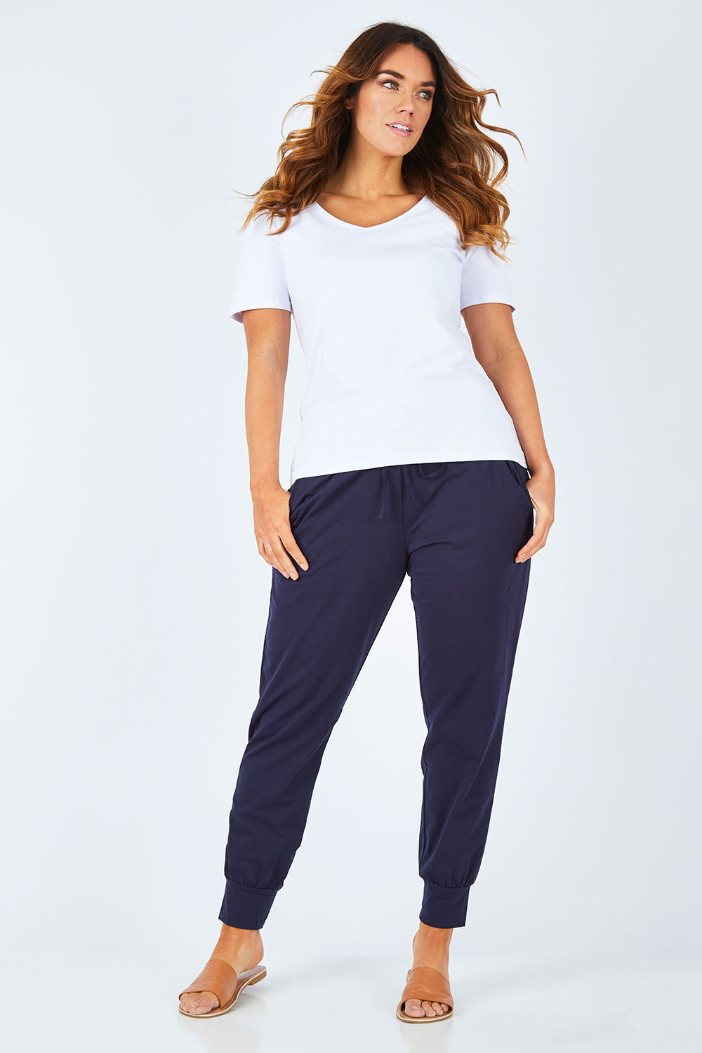 Model Laura wearing size 14 of The Basic Keeper Pant in colour Navy (Blue), from the front, showing the whole outfit