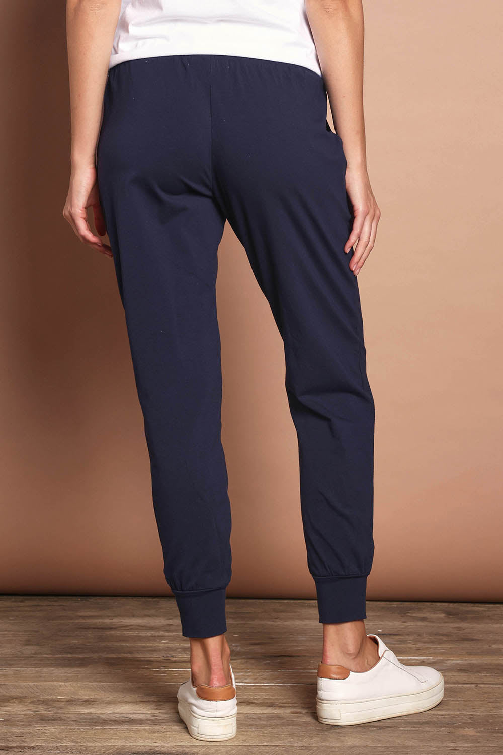 Model Madeline wearing size 10 of The Basic Keeper Pant in colour Navy (Blue), from the back