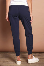 Model Madeline wearing size 10 of The Basic Keeper Pant in colour Navy (Blue), from the back