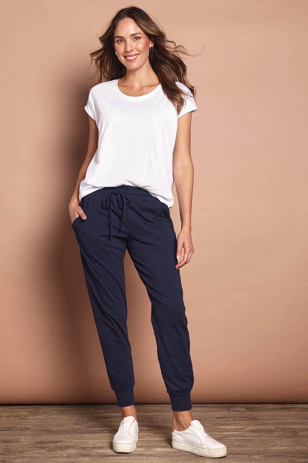 Model Madeline wearing size 10 of The Basic Keeper Pant in colour Navy (Blue), from the front, showing the whole outfit