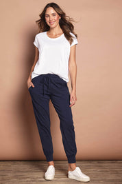 Model Madeline wearing size 10 of The Basic Keeper Pant in colour Navy (Blue), from the front, showing the whole outfit
