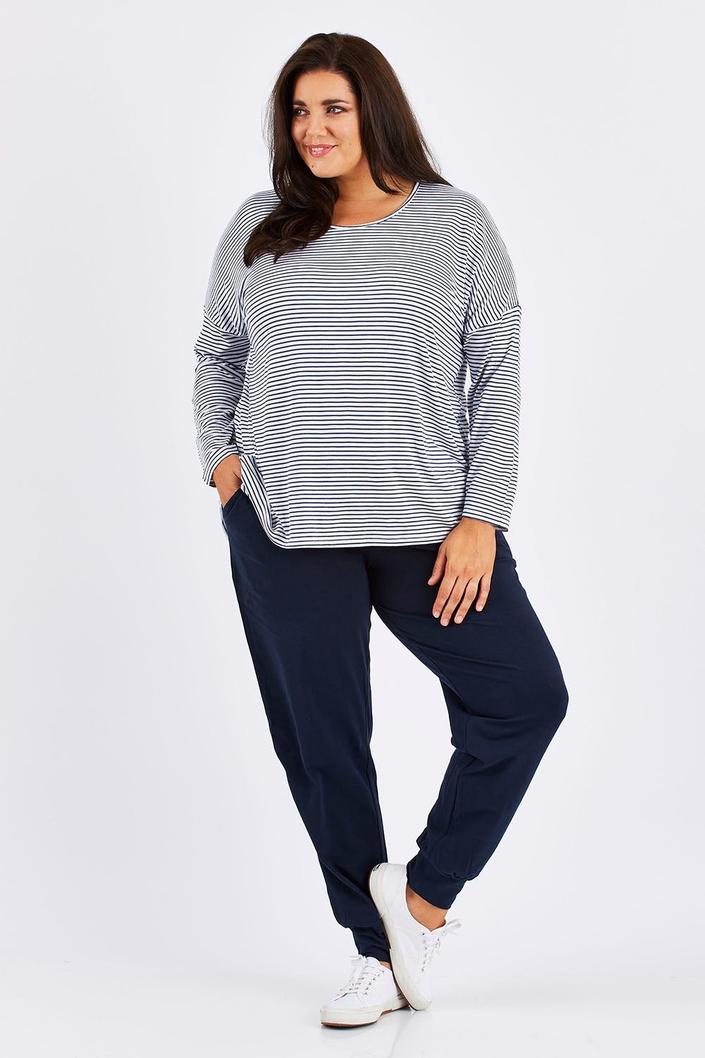 Model Mae wearing size 18 of The Basic Keeper Pant in colour Navy (Blue), from the front, showing the whole outfit
