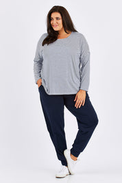 Model Mae wearing size 18 of The Basic Keeper Pant in colour Navy (Blue), from the front, showing the whole outfit
