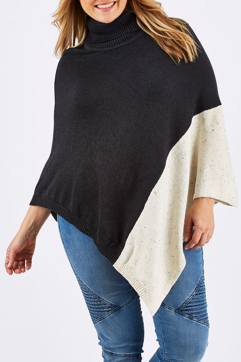 Model Ljubenka wearing The Panel Knit Poncho in colour Charcoal (Black), from the front, cropped image