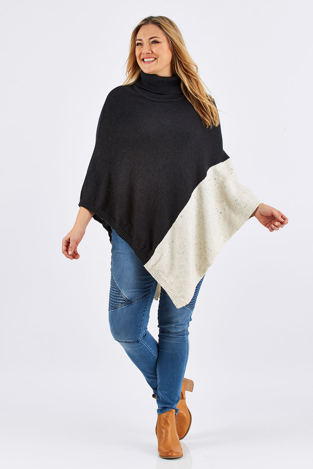 Model Ljubenka wearing The Panel Knit Poncho in colour Charcoal (Black), from the front, showing the whole outfit